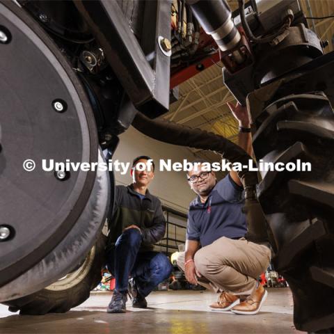 BSE Professors Yufeng Ge (left) and Santosh Pitla inspect the Flexible Robot, or Flex-Ro, which is outfitted with sensors that collect data and help the vehicle avoid obstacles. A planter for Mars would be much smaller so it can be transported easier and also because the “fields” would probably be in enclosed spaces. Photo illustration for Space 2, the Nebraska Grand Challenge led by professors in Biological Systems Engineering to grow crops on Mars. October 20, 2023. Photo by Craig Chandler / University Communication.