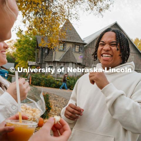 Amani Mfinanga laughs with fellow Cheer Squad members at Roca Berry Farms. About Lincoln at Roca Berry Farm. October 22, 2023. Photo by Matthew Strasburger / University Communication.