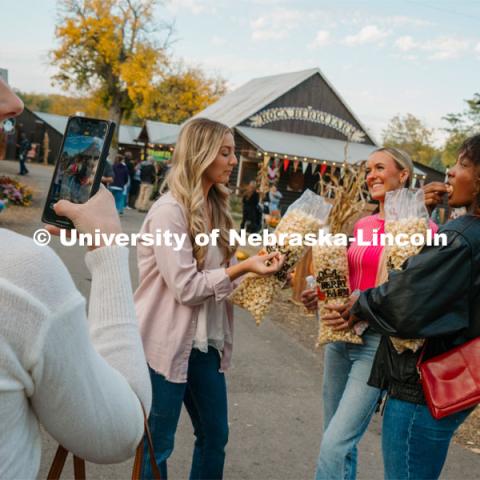 Husker Cheer Squad enjoy some popcorn at Roca Berry Farm. About Lincoln at Roca Berry Farm. October 22, 2023. Photo by Matthew Strasburger / University Communication.