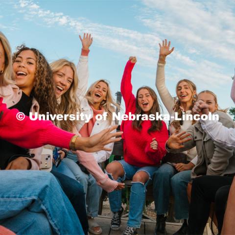 Members of the Husker Cheer Squad on a hay rack ride at Roca Berry Farm. About Lincoln at Roca Berry Farm. October 22, 2023. Photo by Matthew Strasburger / University Communication.