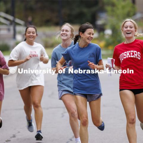 Team Delta Gamma runs through East Campus collecting their clues. Homecoming Traditions Race. Registered teams compete in a race to find 10 landmarks in an hour on UNL’s East Campus. October 24, 2023. Photo by Craig Chandler / University Communication.