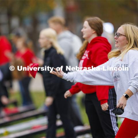 Morgan Weber lets a bag fly during Homecoming Cornhole Tournament in the greenspace by the Nebraska Union. She was competing for Pi Phi. October 25, 2023. Photo by Craig Chandler / University Communication.