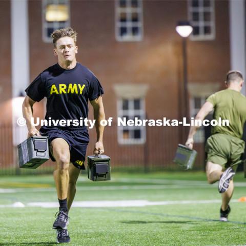 Nebraska cadets and midshipmen race carrying weighted ammo containers. ROTC Joint Field Meet is like an ROTC Olympics for the Nebraska cadets and midshipmen. Army, Air Force and Navy/Marine cadets and midshipmen compete in events such as Maneuvering Under Fire, Log Sit-ups, Tug-Of-War, Casualty Evacuation and Ultimate Frisbee. Army beat Navy in a sudden death 4x400 relay to claim the title. October 26, 2023. Photo by Craig Chandler / University Communication.