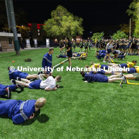 Air Force and Navy/Marine cadets and midshipmen prepare to leap up and start pulling the tug of war rope. ROTC Joint Field Meet is like an ROTC Olympics for the Nebraska cadets and midshipmen. Army, Air Force and Navy/Marine cadets and midshipmen compete in events such as Maneuvering Under Fire, Log Sit-ups, Tug-Of-War, Casualty Evacuation and Ultimate Frisbee. Army beat Navy in a sudden death 4x400 relay to claim the title. October 26, 2023. Photo by Craig Chandler / University Communication.