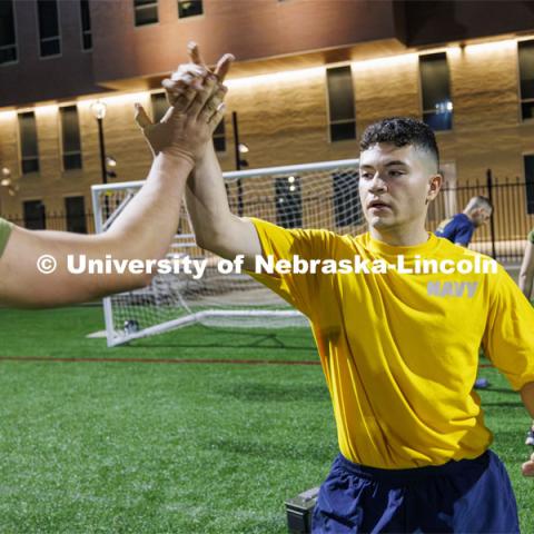 Navy midshipman Matthew Alarcon receives a high-five. ROTC Joint Field Meet is like an ROTC Olympics for the Nebraska cadets and midshipmen. Army, Air Force and Navy/Marine cadets and midshipmen compete in events such as Maneuvering Under Fire, Log Sit-ups, Tug-Of-War, Casualty Evacuation and Ultimate Frisbee. Army beat Navy in a sudden death 4x400 relay to claim the title. October 26, 2023. Photo by Craig Chandler / University Communication.