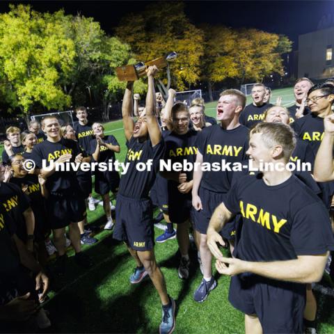 Cadet Remy Abdulahi hoists the trophy after the Army cadets won the meet. ROTC Joint Field Meet is like an ROTC Olympics for the Nebraska cadets and midshipmen. Army, Air Force and Navy/Marine cadets and midshipman compete in events such as Maneuvering Under Fire, Log Sit-ups, Tug-Of-War, Casualty Evacuation and Ultimate Frisbee. Army beat Navy in a sudden death 4x400 relay to claim the title. October 26, 2023. Photo by Craig Chandler / University Communication.