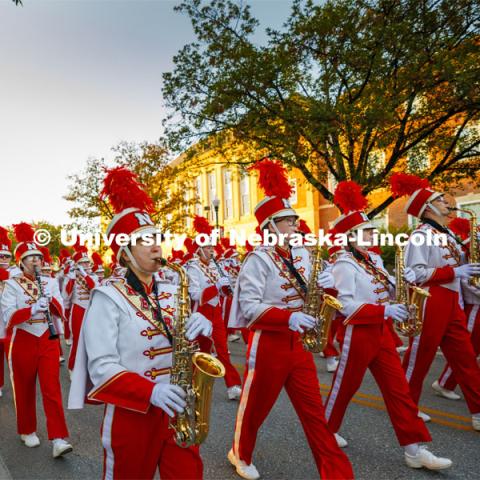 The Cornhusker Marching Band marches down R Street to begin the parade. Homecoming parade and Cornstock. October 27, 2023. Photo by Craig Chandler / University Communication.