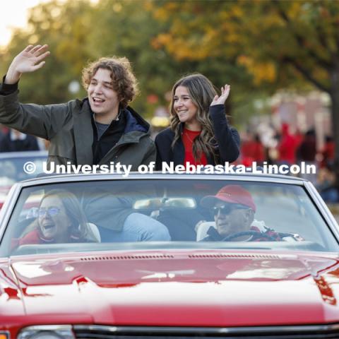 Homecoming royalty candidates Cordell Vrbka and Rachel Morros wave to the crowd along the parade route. Homecoming parade and Cornstock. October 27, 2023. Photo by Craig Chandler / University Communication.