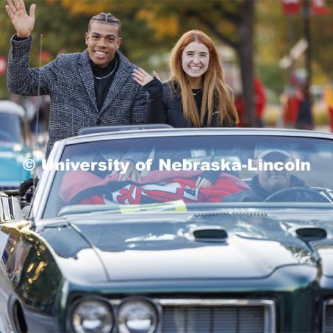 Homecoming royalty candidates Samuel Phillips and Hannah-Kate Kinney wave to the crowd along the parade route. Homecoming parade and Cornstock. October 27, 2023. Photo by Craig Chandler / University Communication.