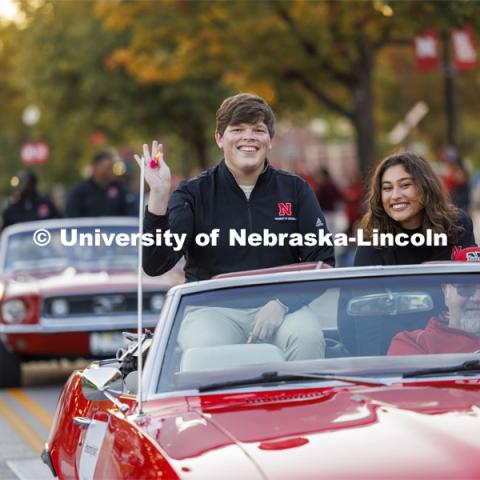 Homecoming royalty candidates Preston Kotik and Ritsa Giannakas wave to the crowd along the parade route. Homecoming parade and Cornstock. October 27, 2023. Photo by Craig Chandler / University Communication.