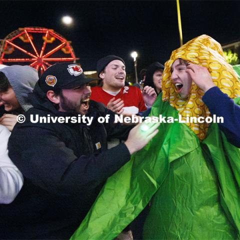 James Lynch with Phi Kappa Psi is mobbed by his friends after winning the jester competition. Homecoming parade and Cornstock. October 27, 2023. Photo by Craig Chandler / University Communication.