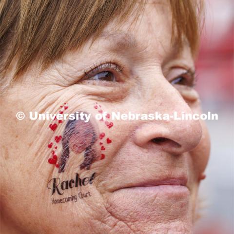 Cari Cohn-Morros wears a temporary tattoo of her daughter, Rachel Morros. Rachel is one of this year’s homecoming court. Cari was on the UNL homecoming court in 1981. Nebraska football versus Purdue Homecoming game. October 28, 2023. Photo by Craig Chandler / University Communication.