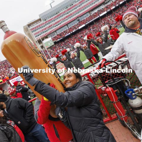 Homecoming Royalty candidate Isha Kishore shoots Der Viener Schlinger at the Nebraska football versus Purdue Homecoming game. Seniors Hannah-Kate Kinney of Omaha and Preston Kotik of Hooper have been crowned homecoming royalty at the University of Nebraska–Lincoln. October 28, 2023. Photo by Craig Chandler / University Communication.