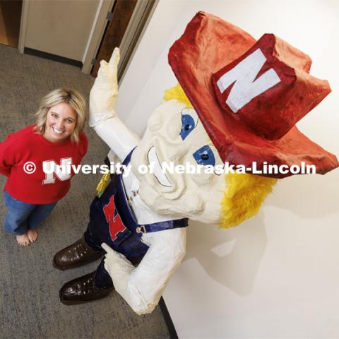 Ashley Dohe, Administrative Coordinator for Electrical and Computer Engineering, has made an 8-foot tall Herbie Husker from paper- mâché. She hopes to auction it off to help veterans. October 30, 2023. Photo by Craig Chandler / University Communication.