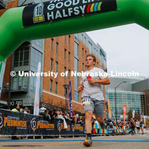 Runners cross the finish line. The Good Life Halfsy half marathon runs through the streets of Lincoln and end downtown in the Haymarket. About Lincoln at the Good Life Halfsy. November 5, 2023. Photo by Matthew Strasburger / University Communication.