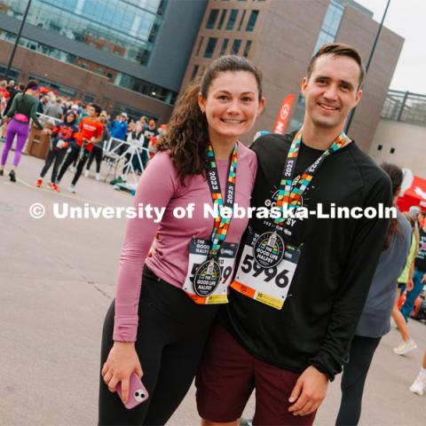 Runners pose for a picture with their medals. The Good Life Halfsy half marathon runs through the streets of Lincoln and end downtown in the Haymarket. About Lincoln at the Good Life Halfsy. November 5, 2023. Photo by Matthew Strasburger / University Communication.