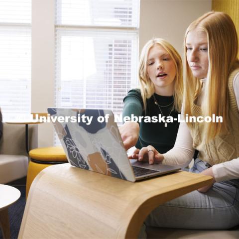 Madalyn Schoneman, center, and Alexis Tenorio look over work on the laptop as Sarah Danahy studies in the Knoll Residential Center lounge. A University of Nebraska–Lincoln team’s proposed renovation of a little-used TV lounge in the Robert E. Knoll Residential Center features multiple study spaces designed to allow for collaboration between students won the 2019 Big Ten Academic Alliance Student Design Challenge. Following pandemic delays, the furniture has been delivered. The annual contest, supported by the Herman Miller furniture company, allows students to develop and pitch a renovation of an existing campus space. November 17, 2023. Photo by Craig Chandler / University Communication and Marketing.
