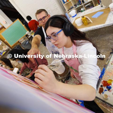 Sarah Preston, a sophomore from Gering, Nebraska, receives some color advice from Aaron Holz. Students work on their master study painting in Aaron Holz’ PANT 251: Beginning Painting course in Richards Hall. November 29, 2023. Photo by Craig Chandler / University Communication and Marketing.