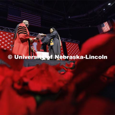 Marlenia Jewell Thornton receives her MBA diploma from Chancellor Rodney Bennett. Graduate Commencement at Pinnacle Bank Arena. December 15, 2023. Photo by Craig Chandler / University Communication and Marketing.