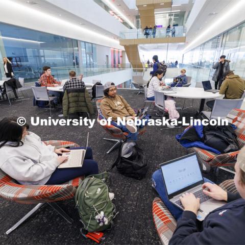 Students sit in study areas Monday morning awaiting their first classes. First day of classes in Kiewit Hall. January 22, 2024. Photo by Craig Chandler / University Communication and Marketing.