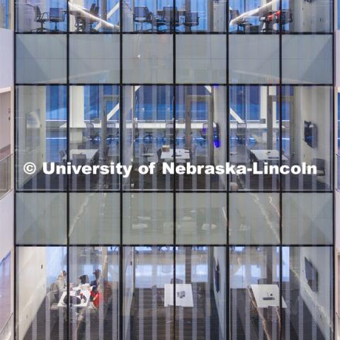 Looking through the glass into the classrooms from the atrium of the inside of Kiewit Hall. January 25, 2024. Photo by Craig Chandler / University Communication and Marketing.