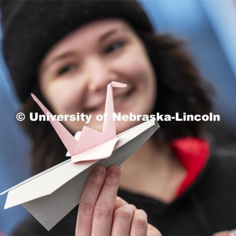 Keilani Mielke, a computer engineering student, added a graceful paper swan pilot to her plane. Engineering students, staff and faculty finished out the first week of classes in the new Kiewit Hall by having a paper airplane contest in the atrium. Contestants flew three rounds of flights aiming at a bullseye on the first floor. January 26, 2024. Photo by Craig Chandler / University Communication and Marketing.