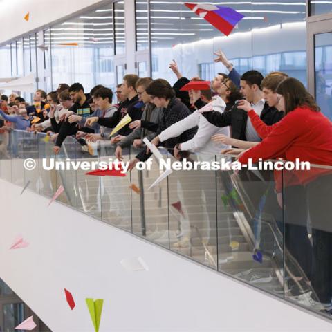 Engineering students, staff and faculty finished out the first week of classes in the new Kiewit Hall by having a paper airplane contest in the atrium. Contestants flew three rounds of flights aiming at a bullseye on the first floor. A fourth throw in unison filled the atrium with planes. January 26, 2024. Photo by Craig Chandler / University Communication and Marketing.