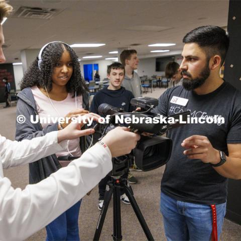 Alex Fernando checks to see if Lefler Middle School student Kaleigh Stockard-Smith can hear the interviewee as College of Journalism and Mass Communications Ambassador Harmon Johnsen adjusts the sound levels. Fernando leads a workshop for students from LPS’ Lefler Middle School. Fernando and College of Journalism and Mass Communications ambassadors had the students taking photos, doing video shooting, social media posts and an advertising campaign. February 7, 2024. Photo by Craig Chandler / University Communication and Marketing.