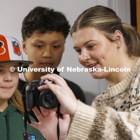 College of Journalism and Mass Communications Ambassador Faith Worden helps students look at their photos during a workshop for students from LPS’ Lefler Middle School. Fernando and College of Journalism and Mass Communications ambassadors had the students taking photos, doing video shooting, social media posts and an advertising campaign. February 7, 2024. Photo by Craig Chandler / University Communication and Marketing.