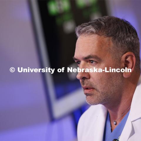 Dr. Theodoros “Ted” Voloyiannis of Texas Colon and Rectal Specialties in Houston, TX, concentrates while using the Space MIRA. Nebraska Engineering professor and Virtual Incision founder Shane Farritor successfully performed robotic surgery on the International Space Station. Controlled from the Virtual Incision offices in Lincoln, NE, surgeons cut rubber bands–mimicking surgery–inside a payload box on the International Space Station. February 10, 2024. Photo by Craig Chandler / University Communication and Marketing.