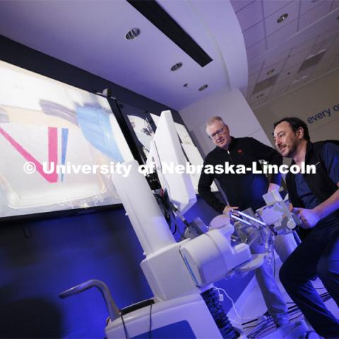 Francesco Bianco, University of Illinois, Chicago, concentrates while using the Space MIRA as Nebraska Engineering professor and Virtual Incision founder Shane Farritor watches. Farritor successfully performed robotic surgery on the International Space Station. Controlled from the Virtual Incision offices in Lincoln, NE, surgeons cut rubber bands–mimicking surgery–inside a payload box on the International Space Station. February 10, 2024. Photo by Craig Chandler / University Communication and Marketing.