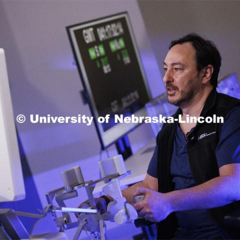 Francesco Bianco, University of Illinois, Chicago, concentrates while using the Space MIRA. Shane Farritor successfully performed robotic surgery on the International Space Station. Controlled from the Virtual Incision offices in Lincoln, NE, surgeons cut rubber bands–mimicking surgery–inside a payload box on the International Space Station. February 10, 2024. Photo by Craig Chandler / University Communication and Marketing.