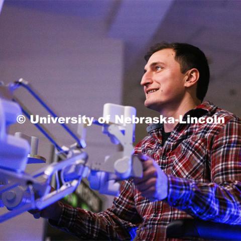 Virtual Incision employee Lou Cubrich gets a chance at surgically cutting a rubber band on the International Space Station. Nebraska Engineering professor and Virtual Incision founder Shane Farritor successfully performed robotic surgery on the International Space Station. Controlled from the Virtual Incision offices in Lincoln, NE, surgeons cut rubber bands–mimicking surgery–inside a payload box on the International Space Station. February 10, 2024. Photo by Craig Chandler / University Communication and Marketing.