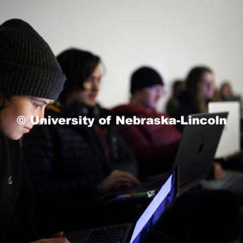 Olivia Priefert checks the notes on the laptop as Adrian Wisnicki teaches his Being Human in a Digital Age course where AI is being taught and discussed. February 12, 2024. Photo by Craig Chandler / University Communication and Marketing.