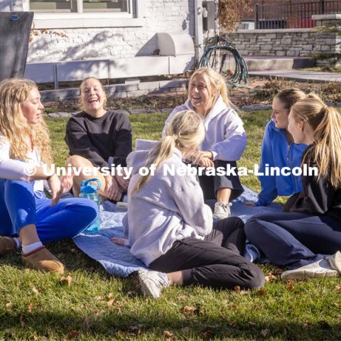 Kappa Kappa Gamma Sorority sisters sit outside on their front lawn chatting. February 20, 2024. Photo by Kristen Labadie / University Communication.