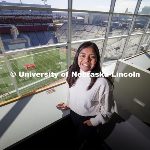 Marissa Kraus, a senior in journalism, poses for a picture in the media box in Memorial Stadium. As a sportswriter, she spent much of her college career covering the Huskers. For Women’s History Month story. February 20, 2023. Photo by Craig Chandler / University Communication and Marketing.