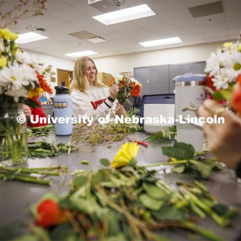 Emma Dostal, a senior Advertising and Public Relations student adds a flower to her bouquet in PLAS 261 - Floral Design I in the Plant Science Building. February 21, 2024. Photo by Craig Chandler / University Communication and Marketing.