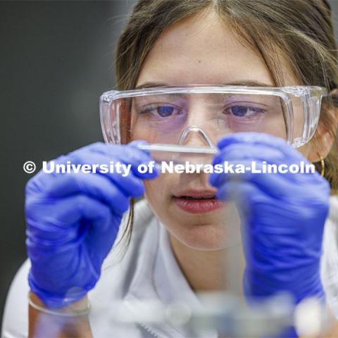 Grace Henry looks at a fluid sample. LIFE 120L - Fundamentals of Biology lab in Manter Hall. February 22, 2024. Photo by Craig Chandler / University Communication and Marketing.