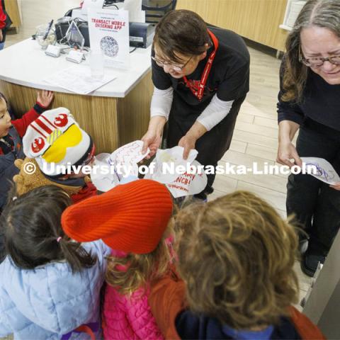 Children crowd in to give appreciation hearts to the food service workers in the Nebraska East Union. Students in the Ruth Staples Child Development Lab go on a field trip to the Nebraska East Union and a walk around campus. March 1, 2024. Photo by Craig Chandler / University Communication and Marketing.