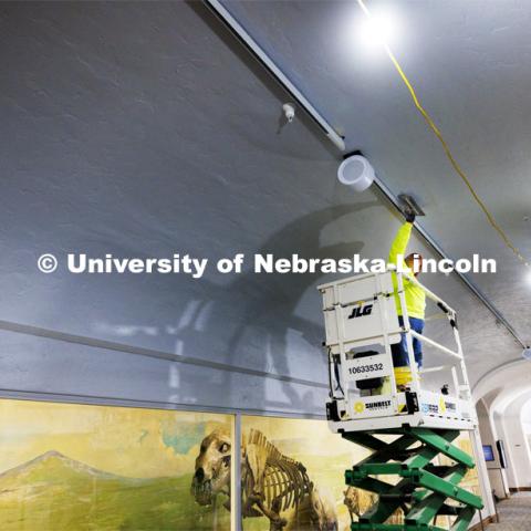 Sara Lopez with Scott’s Quality Plastering and Stucco smooths the ceiling next to the new lighting tracks on the second floor in Morrill Hall. Workers are rushing to finish renovations to improve accessibility and better protect its exhibits and research specimens so the University of Nebraska State Museum and Mueller Planetarium can reopen to the public on March 15, 2024. March 4, 2024. Photo by Craig Chandler / University Communication and Marketing.