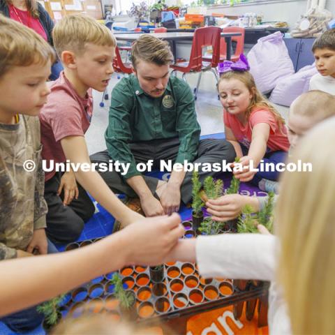 Jack Hilgert has the second graders feel and describe the needles on their Colorado blue spruce trees. Jack Hilgert, Conservation Education Coordinator for the Nebraska Forest Service, teaches second graders about trees at Humboldt-Table Rock-Steinauer school in Humboldt, Nebraska. Each student was given a Colorado blue spruce seedling to raise in the classroom while they learn about trees. March 25, 2024. Photo by Craig Chandler / University Communication and Marketing.