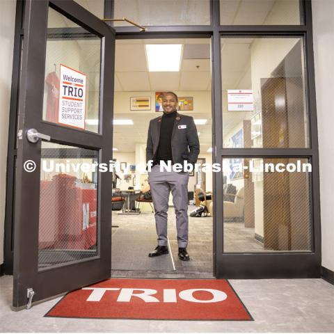 Cameron Woodard, Director of Trio Programs, poses at the doors of the TRIO offices in Canfield Administration Building. March 25, 2024. Photo by Kristen Labadie / University Communication.