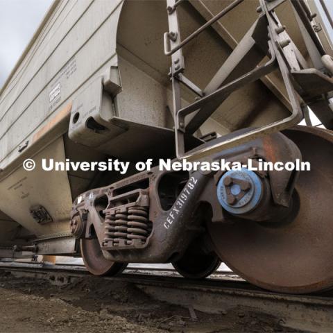 A blue Brenco railcar axle bearing is shown on a railcar. Each railcar has more than 350 bearings to support the load and keep the wheels turning. This railcar was photographed in the Omaha, Lincoln and Beatrice Railway yard with permission from the railway. March 27, 2024. Photo by Craig Chandler / University Communication and Marketing.