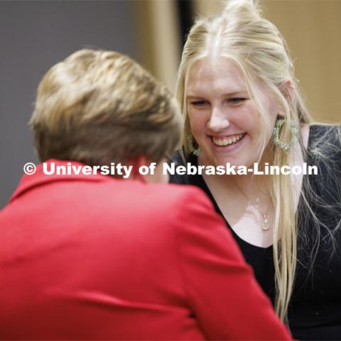 Aspiring teacher Emma Henderson of Superior, Nebraska, accepts her pin from CEHS 2024 alumni master Marilyn Moore. The second-year student has been admitted to the elementary education program in the College of Education and Human Sciences. April 5, 2024. Photo by Craig Chandler / University Communication and Marketing.