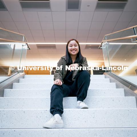 Kiley Pham, a Junior Civil Engineering Major, poses at the top stairwell in Kiewitt Hall as a feature for Pride Month. May 1, 2024. Photo by Kristen Labadie / University Communication.