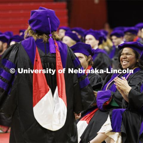 Shannon Mangram, left, and Jordan Malzer, cheer for a fellow graduate. College of Law commencement in Devaney on the volleyball court. May 3, 2024. Photo by Craig Chandler / University Communication and Marketing.