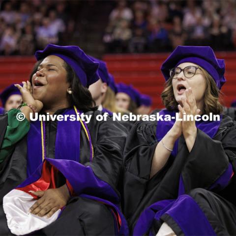 Shannon Mangram, left, and Jordan Malzer, cheer for a fellow graduate. College of Law commencement in Devaney on the volleyball court. May 3, 2024. Photo by Craig Chandler / University Communication and Marketing.