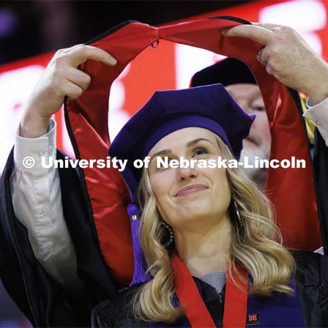 Lauren Kubat receives her hood. College of Law commencement in Devaney on the volleyball court. May 3, 2024. Photo by Craig Chandler / University Communication and Marketing.