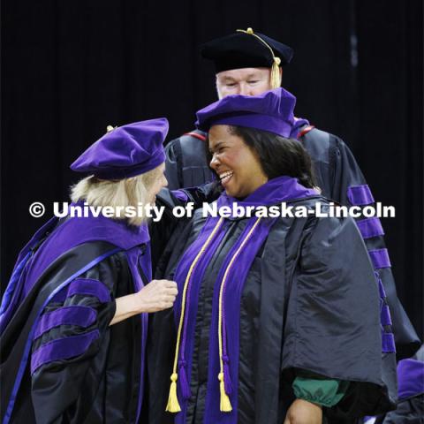 Shannon Mangram smiles after receiving her hood. College of Law commencement in Devaney on the volleyball court. May 3, 2024. Photo by Craig Chandler / University Communication and Marketing.