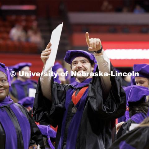 Parker Upton acknowledges his family and friends after Dean Moberly asked the graduates to show their appreciation.  College of Law commencement in Devaney on the volleyball court. May 3, 2024. Photo by Craig Chandler / University Communication and Marketing.